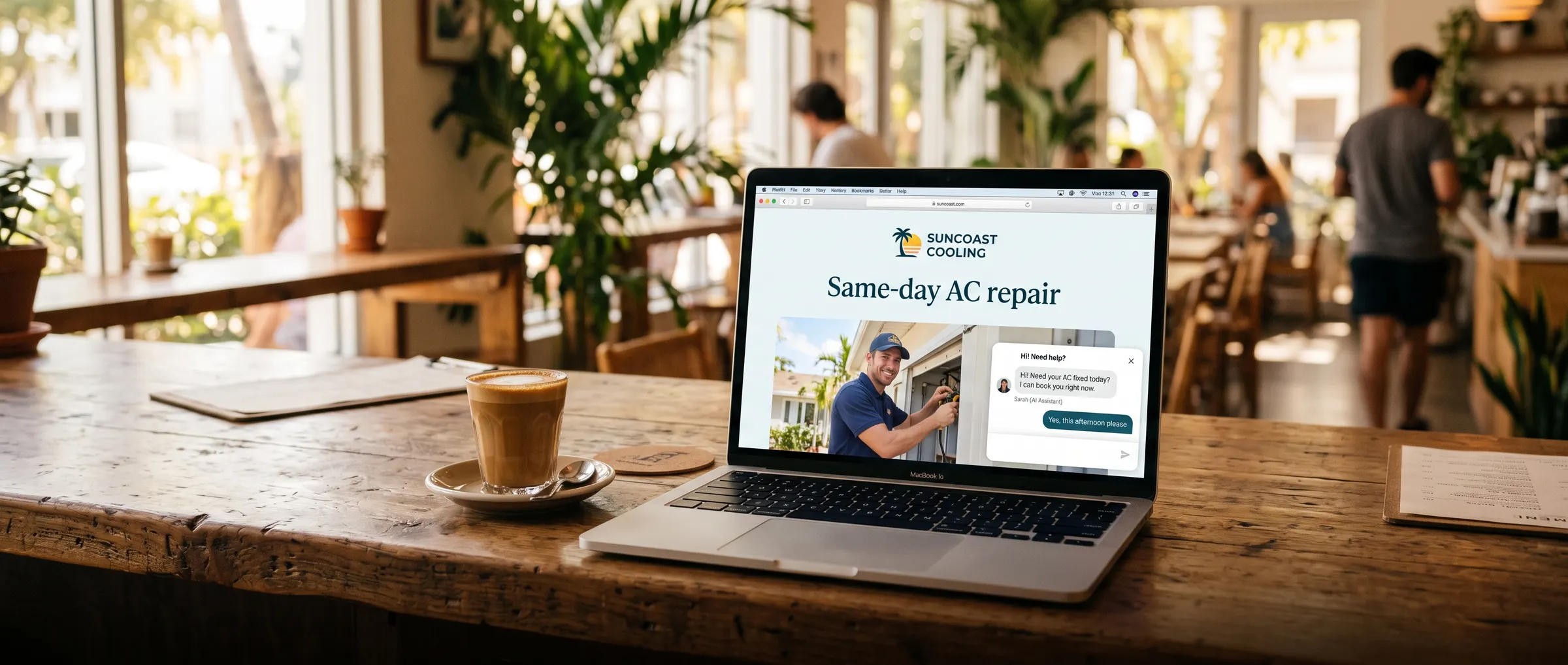 A laptop on a café table showing a website with its chat window open